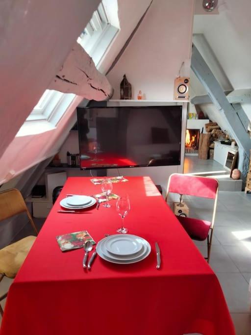 una mesa roja con un mantel rojo sobre una mesa roja sidx sidx en Appartement au coeur Marais, en París