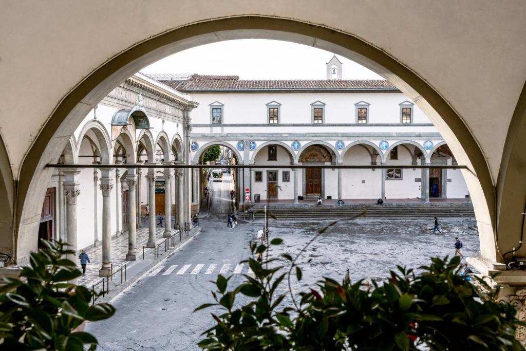 an archway view of a courtyard in a building at Luxury apartment SS Annunziata in Florence