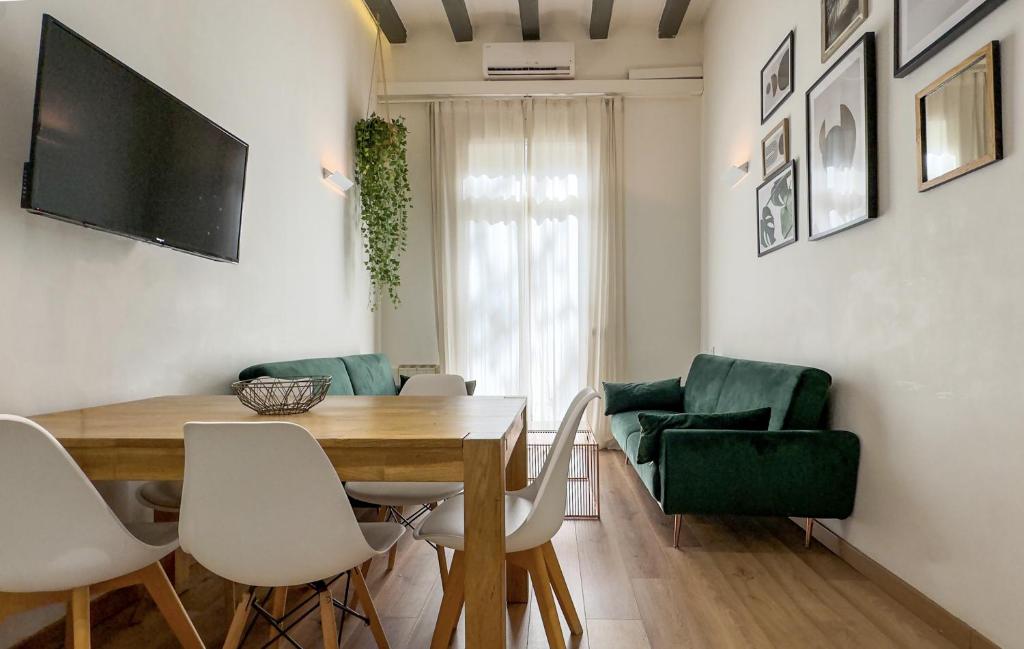 a dining room with a wooden table and chairs at Aqua Apartment by Olala Homes in Barcelona