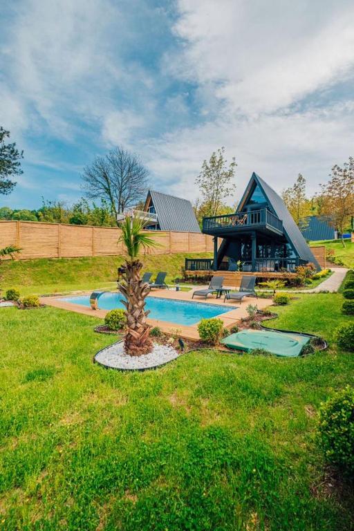 a home with a swimming pool and a house at KAYA PALACE SAPANCA in Sapanca