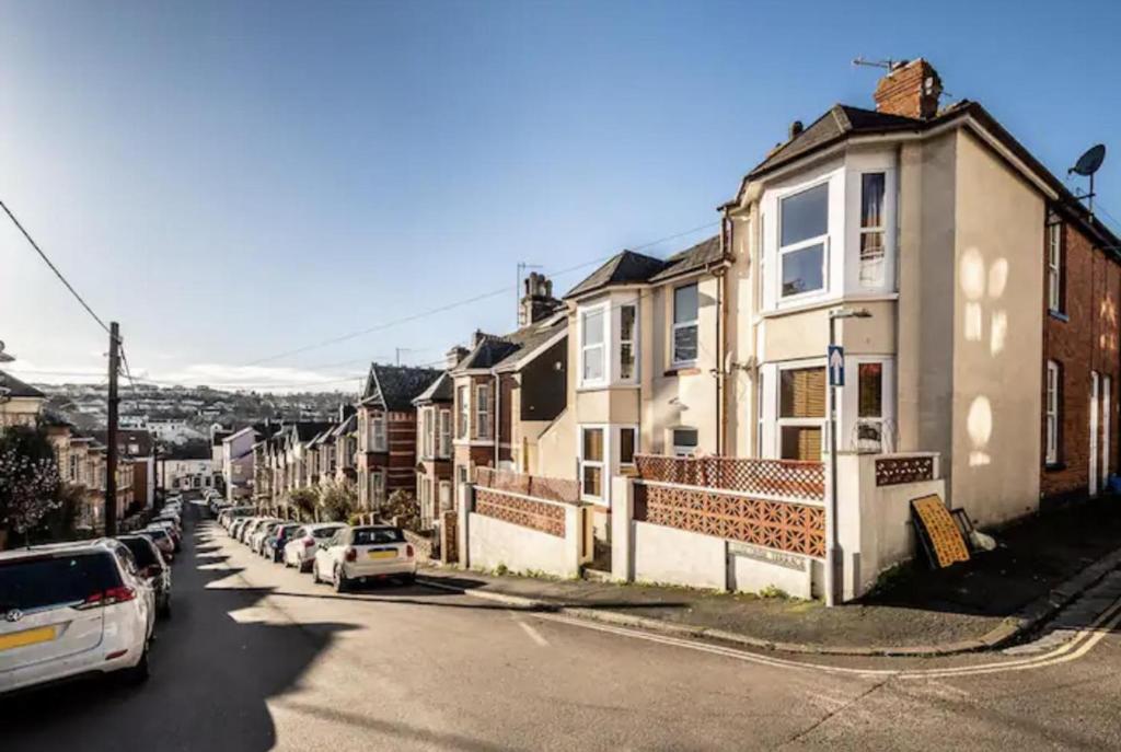 a row of houses on a street with parked cars at The Boat House Sleeps 4 Pet Friendly in Dawlish