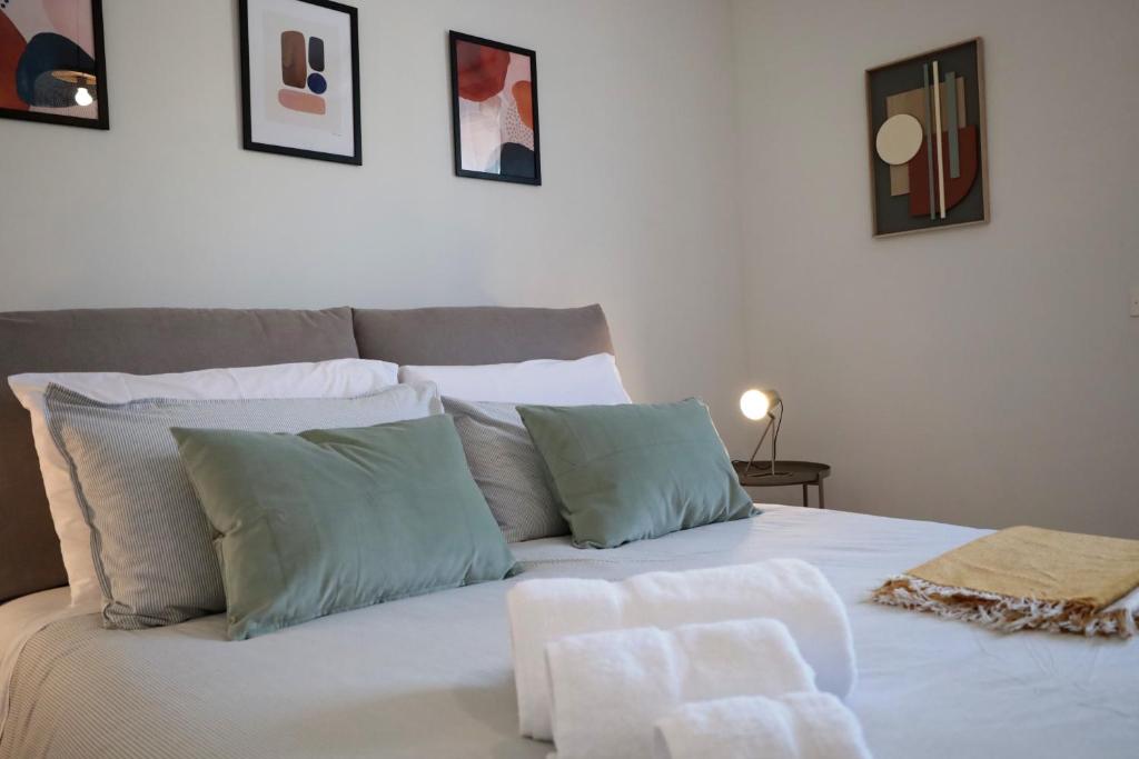 a large white bed with pillows on top of it at Tuscany Best Point [Stazione] in Montale