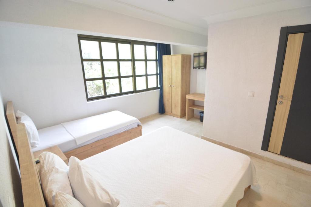 Postel nebo postele na pokoji v ubytování Ados Hotel