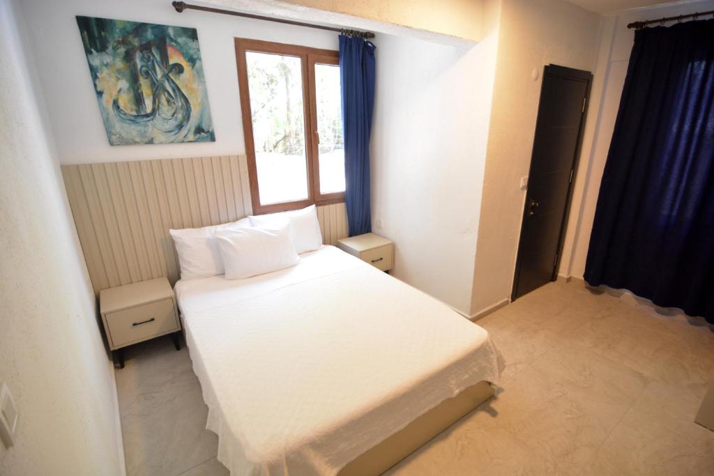 Postel nebo postele na pokoji v ubytování Ados Hotel