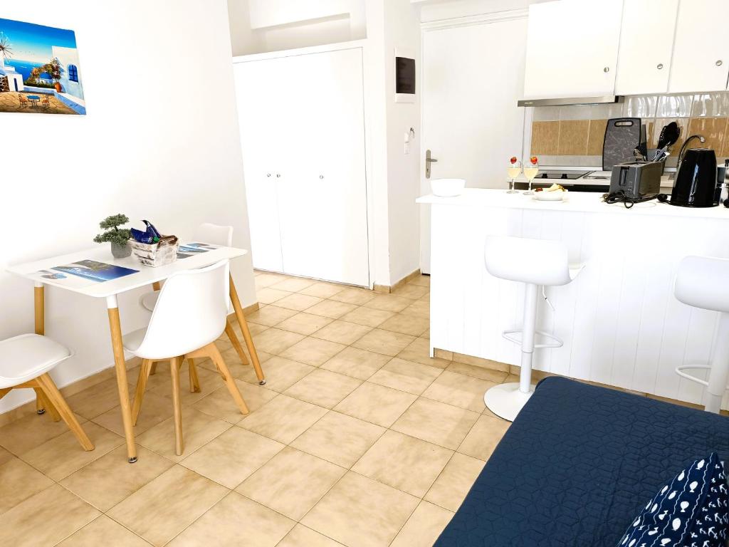 a kitchen with a table and chairs in a room at Nautilus City Studios & Apartments in Rhodes Town