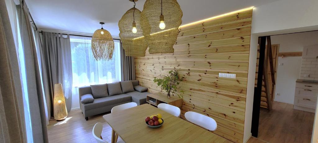 a living room with a table and a couch at Apartamenty Poddąbie1 in Poddąbie