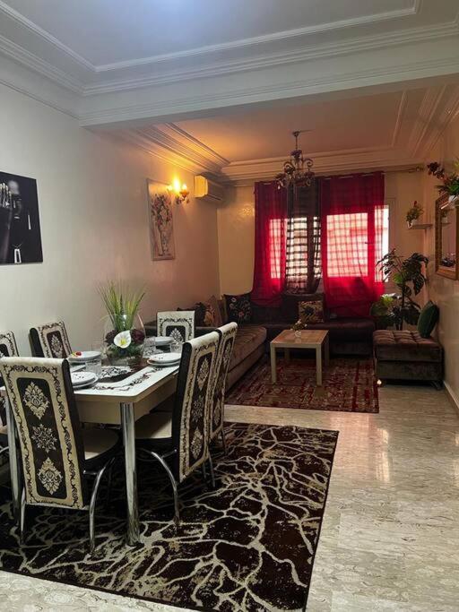 a living room with a dining table and chairs at Beautiful apartment in the city center in Casablanca