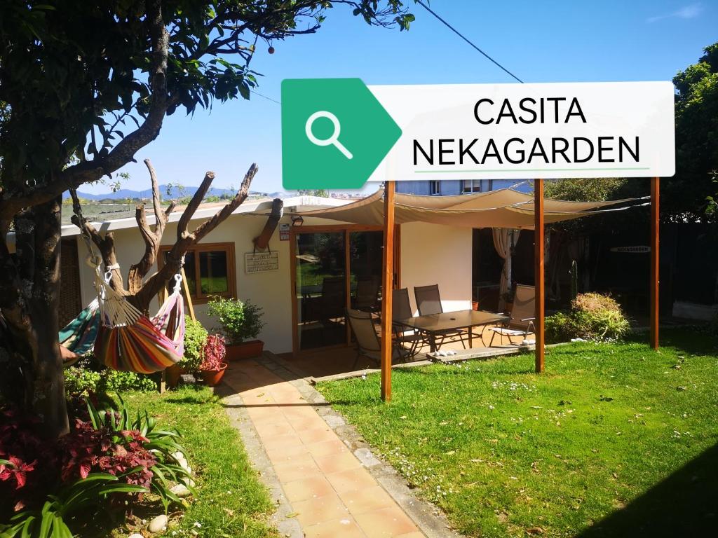 a sign in front of a house with a yard at CASITA NEKAGARDEN in Vigo