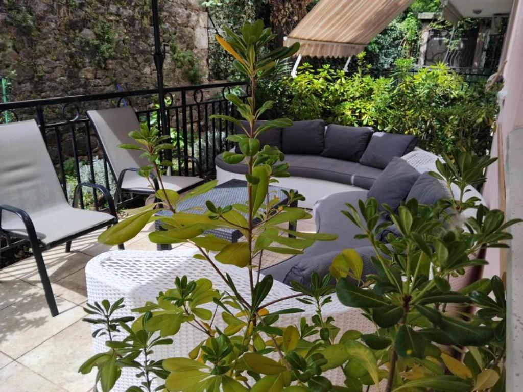 a patio with a couch and some plants at Masa in Baošići