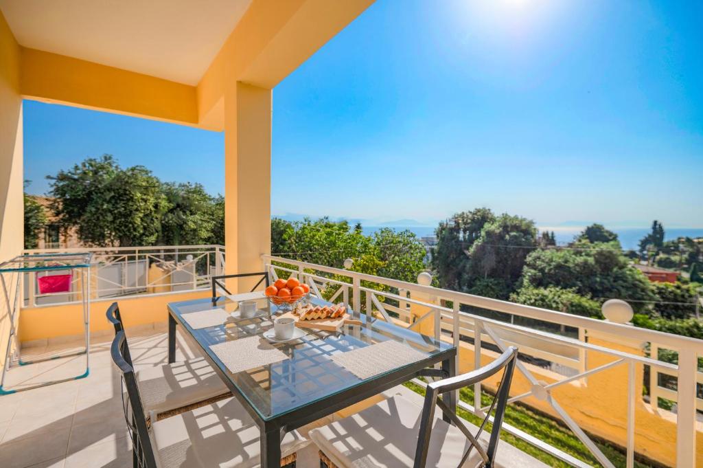 a table and chairs on the balcony of a house at Villa Seasunrise in Perama