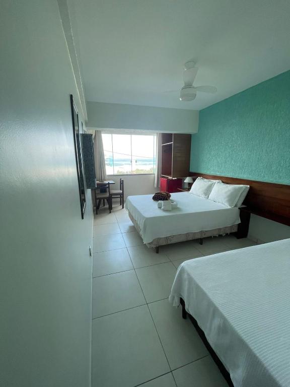 Postel nebo postele na pokoji v ubytování Hotel Aconchego Da Vila