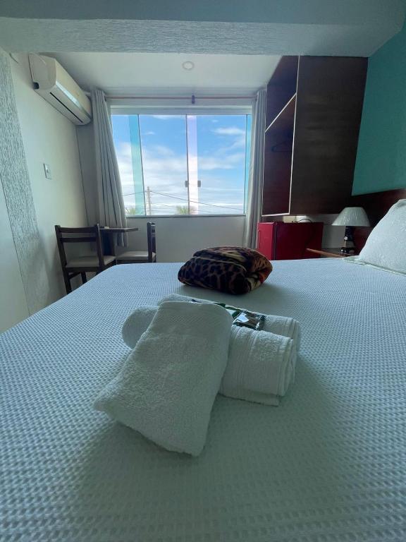 Postel nebo postele na pokoji v ubytování Hotel Aconchego Da Vila