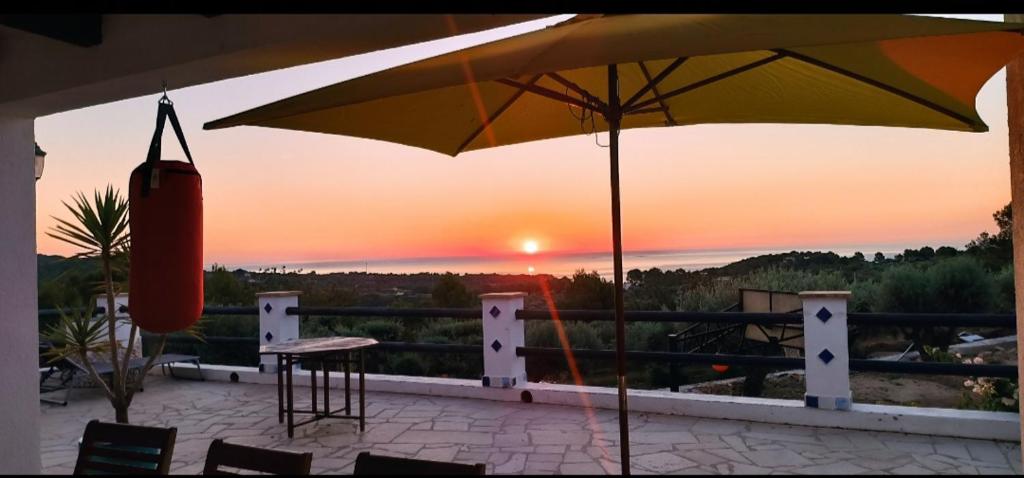 um pátio com um guarda-sol, uma mesa e cadeiras em Flaire Mar em Tarragona