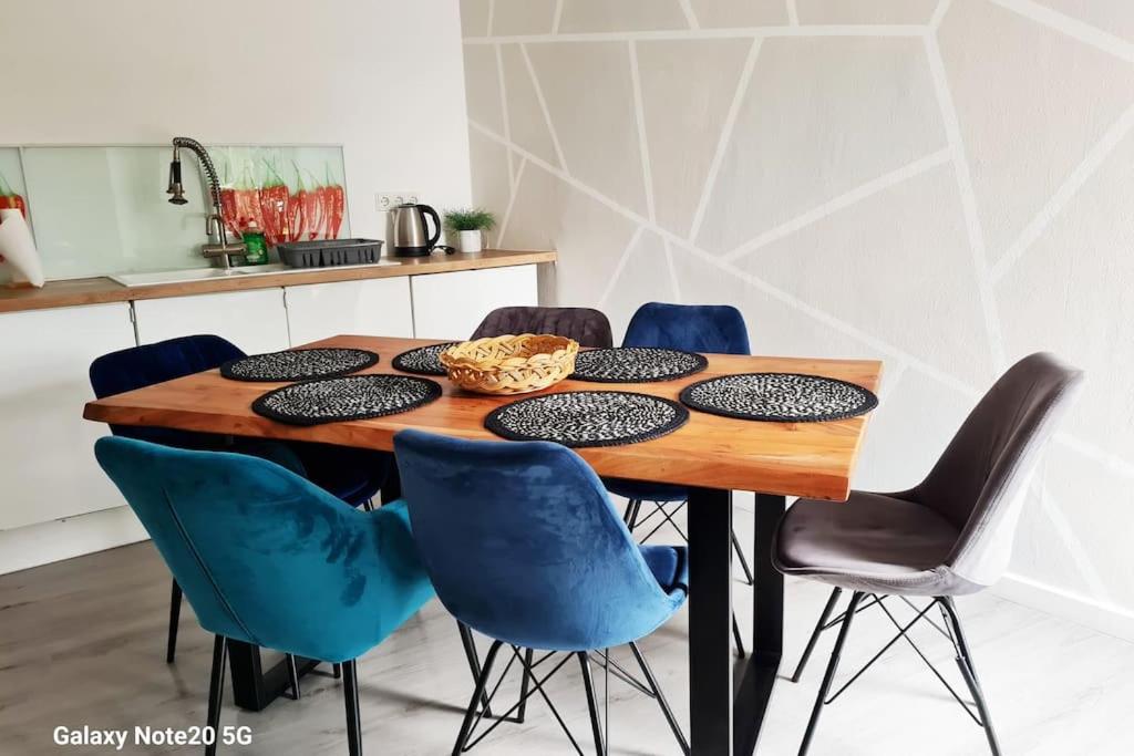 a dining room table with blue chairs around it at Lilias Ruheoase in Pfungstadt