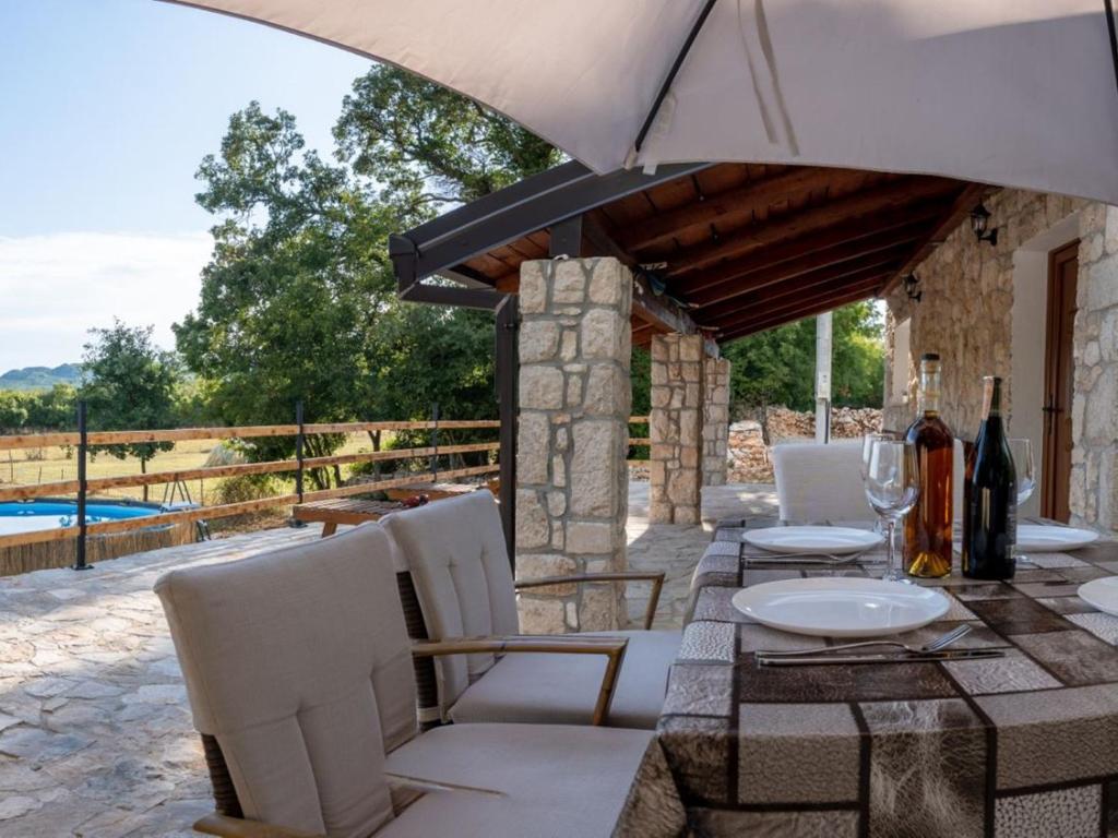 a patio with a table and chairs and a pool at Agroturizam Villa Antonija in Neum