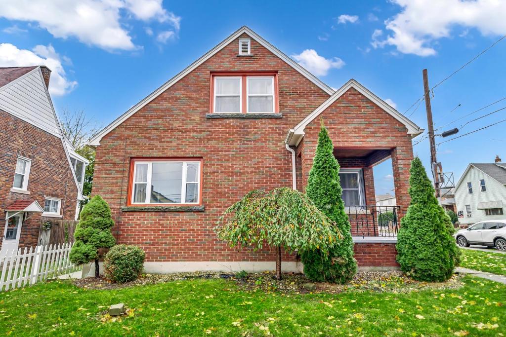 a brick house with trees in the front yard at Best S T R in Niagara Falls NY in Niagara Falls