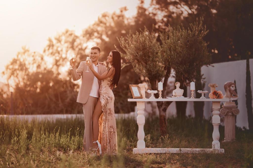 a man and a woman standing next to a table at The Cycladic Pavilion Naxos in Galanádhon