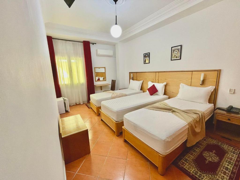 Postel nebo postele na pokoji v ubytování Sary's Hotel