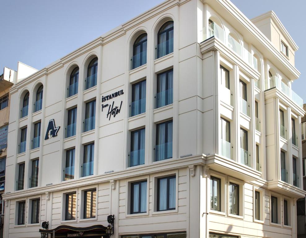 a white building with a sign on it at Istanbul Town Hotel in Istanbul