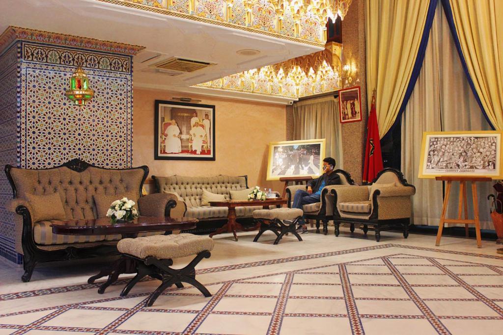 a man sitting in a living room in a building at Majliss Hotel Downtown in Rabat