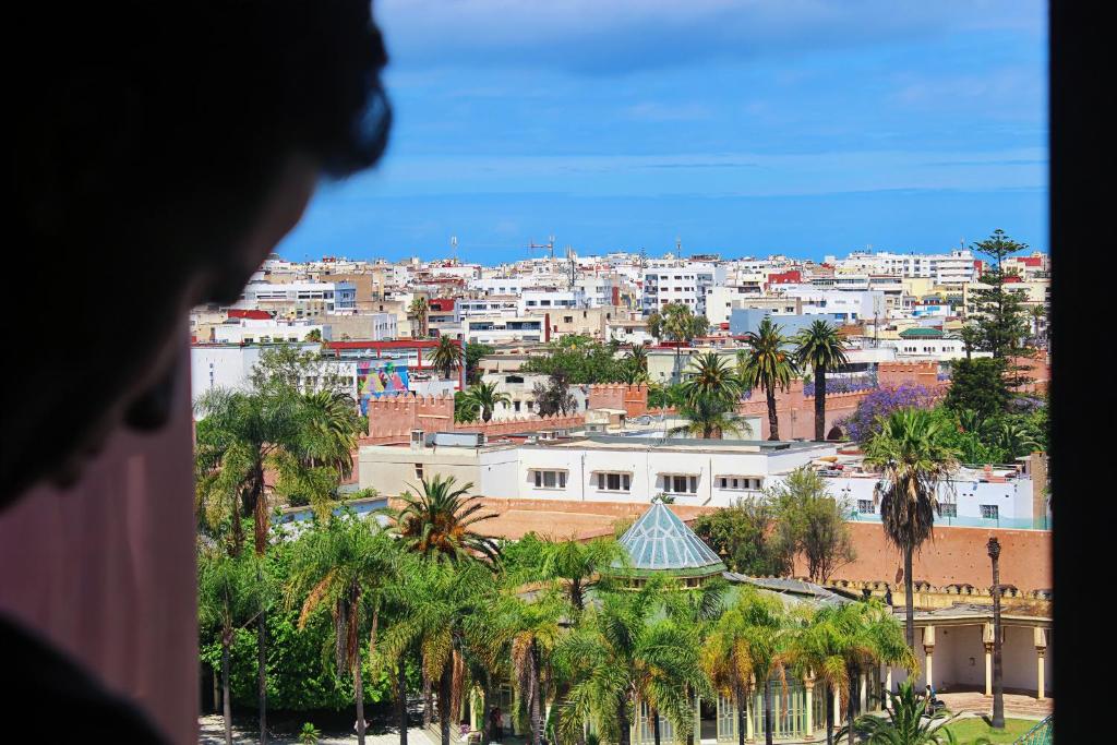 a view of a city with palm trees and buildings at Majliss Hotel Downtown in Rabat