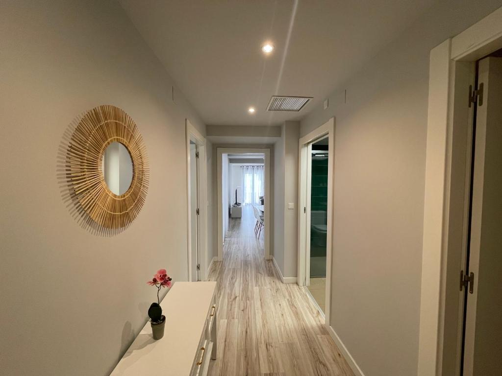 a hallway with a mirror and a wooden floor at Casa Alberto 1 drch in Tudela