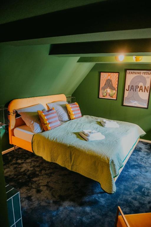 a bedroom with a large bed in a green wall at sleepArt green in Celle