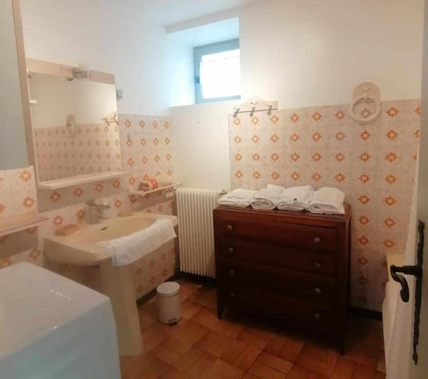 a bathroom with a sink and a toilet and a mirror at Matouchat in Mauzac-et-Grand-Castang