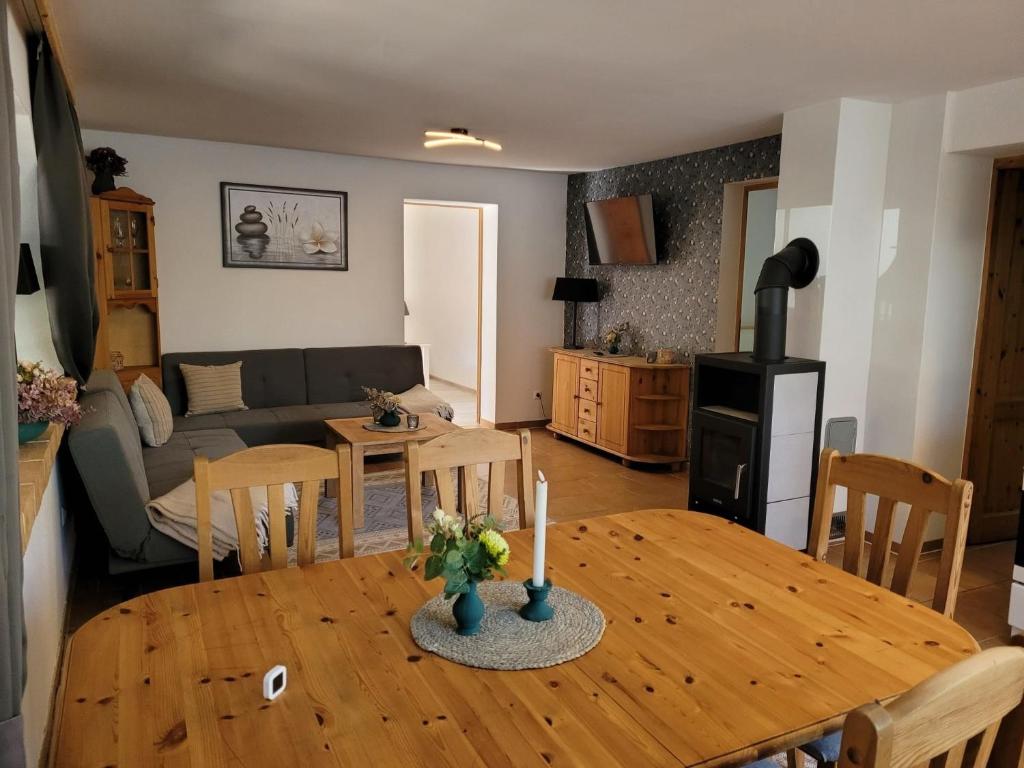 a kitchen and living room with a table and a couch at Ferienwohnung 500m zum See - a55874 in Vollrathsruhe