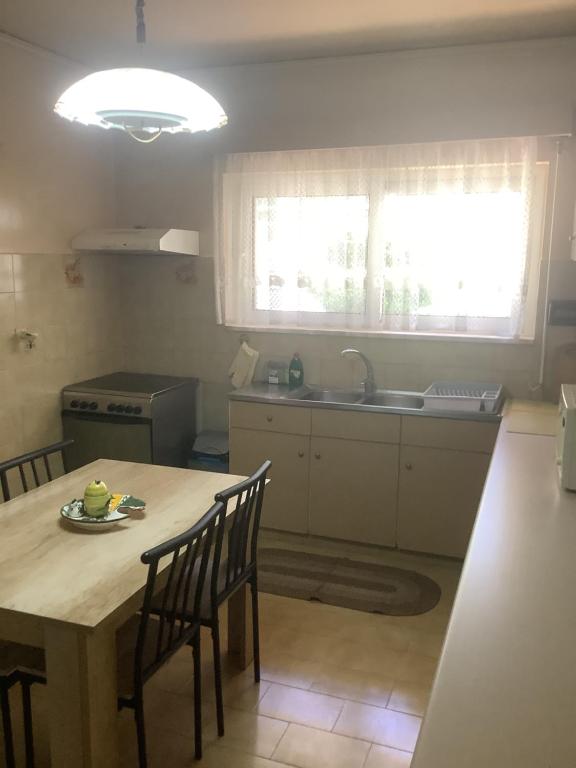 a kitchen with a table and chairs and a sink at Kallipateira apartments in Rhodes Town