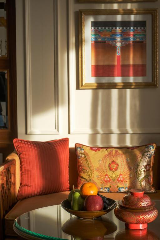 a table with a bowl of fruit on a couch at The Grand Dragon Ladakh in Leh