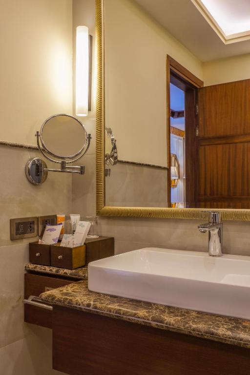 a bathroom with a sink and a mirror at The Grand Dragon Ladakh in Leh