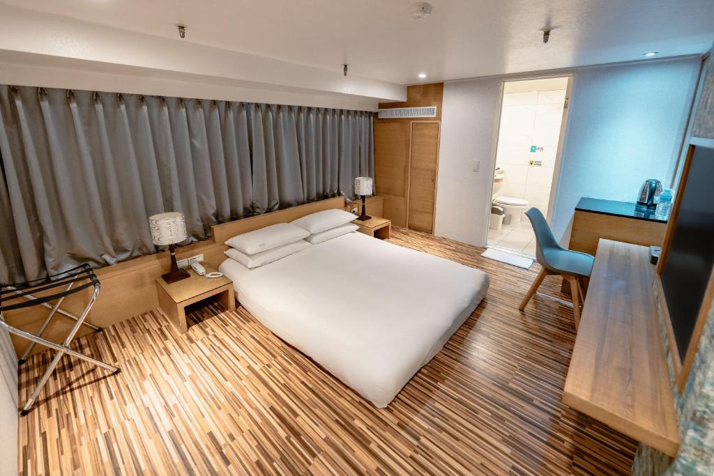 Postel nebo postele na pokoji v ubytování 雲沐行旅 Hotel Cloud Arena-Daan