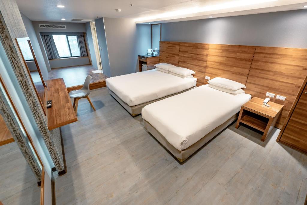 Postel nebo postele na pokoji v ubytování 雲沐行旅 Hotel Cloud Arena-Daan