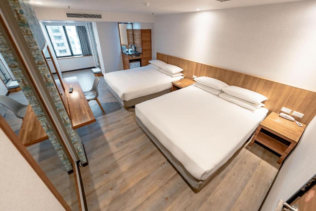 Postel nebo postele na pokoji v ubytování 雲沐行旅 Hotel Cloud Arena-Daan