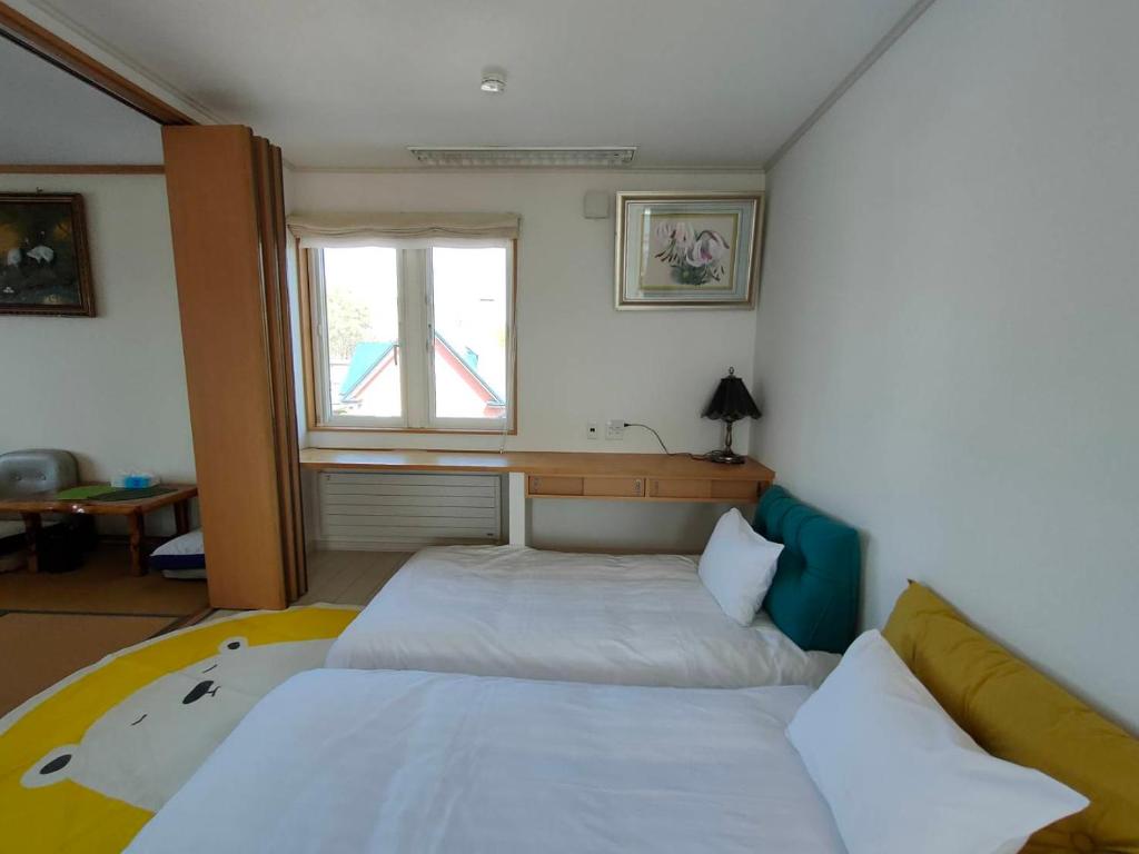 Postel nebo postele na pokoji v ubytování Hokkaido Hakodate Onuma National Park Kenzo's House