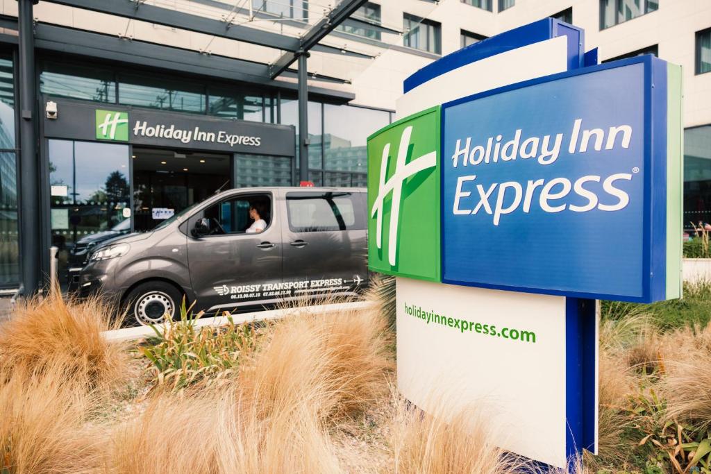 a truck parked in front of a building at Holiday Inn Express - Paris - CDG Airport by IHG in Roissy-en-France