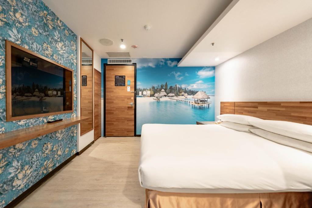 Postel nebo postele na pokoji v ubytování 雲沐行旅 Hotel Cloud Arena-Daan