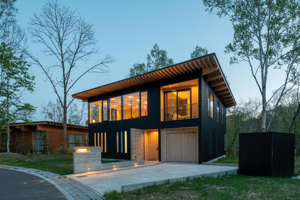 a black house with a garage at Yuki Sugi at Intuition in Kutchan