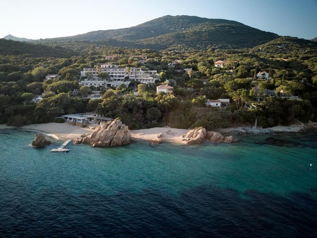 an aerial view of a small island in the water at Hôtel Marinca & Spa in Olmeto