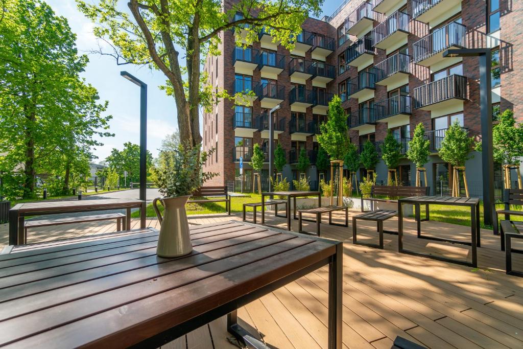 a wooden picnic table in front of a building at Silver Forest in Szczecin