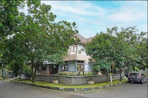 una casa con un coche aparcado delante de ella en Mitra Dago Antapani Syariah en Bandung