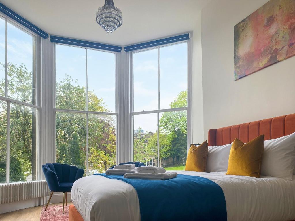 a bedroom with a bed and a large window at The Matcham in Buxton