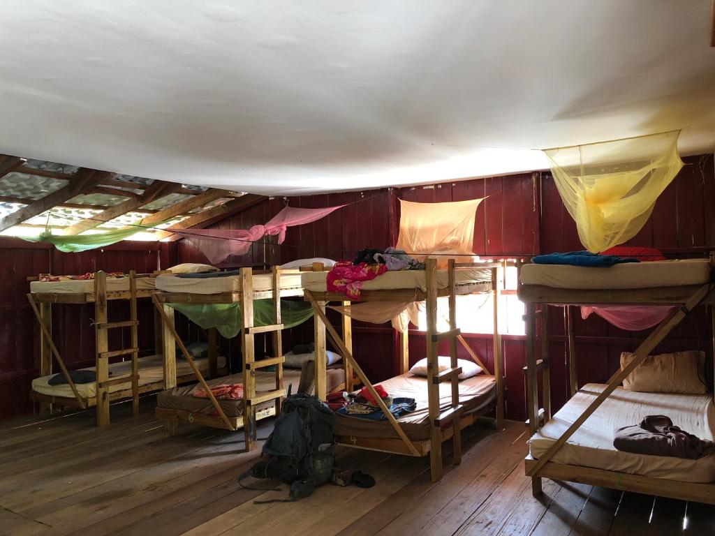 a room filled with lots of bunk beds at The Last Point Koh Takiev in Koh Ta kiev Island