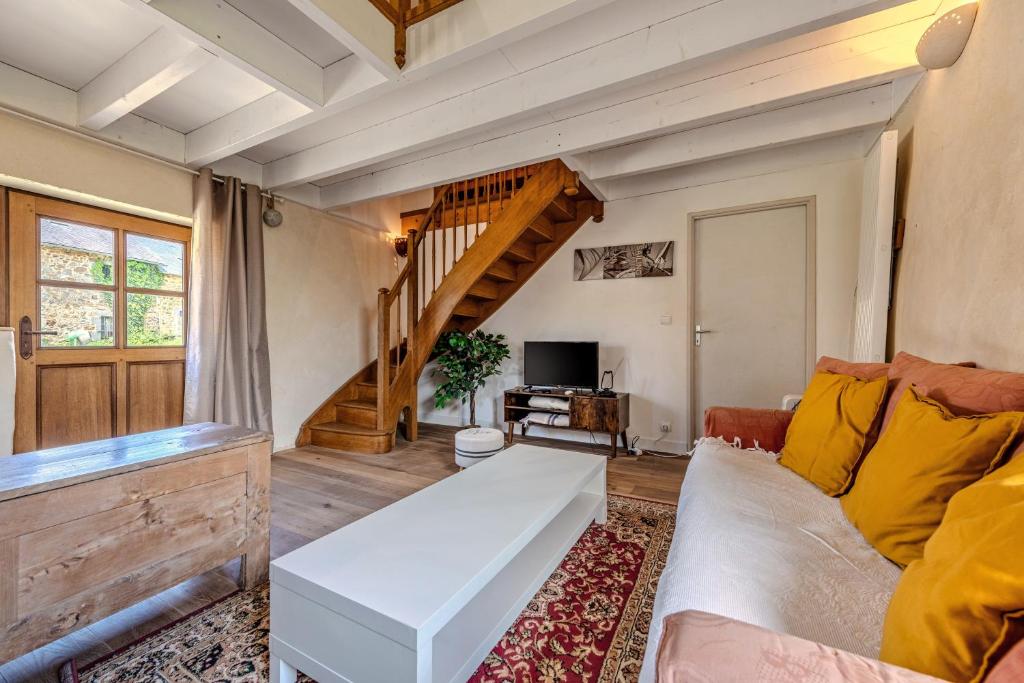 a living room with a couch and a staircase at Ty Forn - Maison à 10min des plages in Plougastel-Daoulas