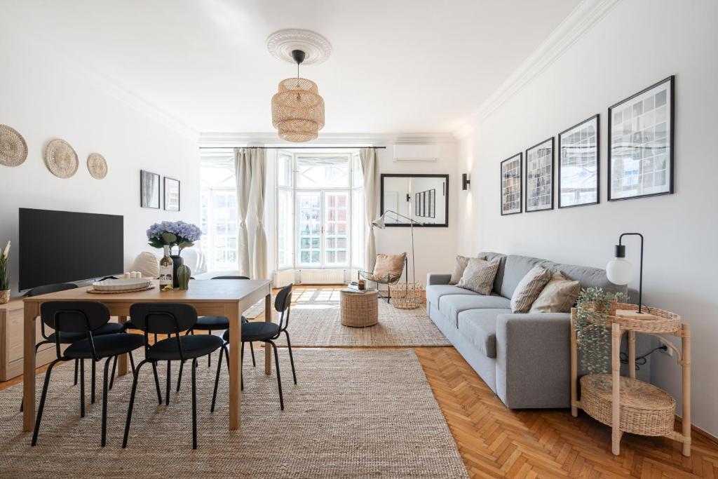 a living room with a couch and a table at NEO Rooftop Home with AC in Budapest