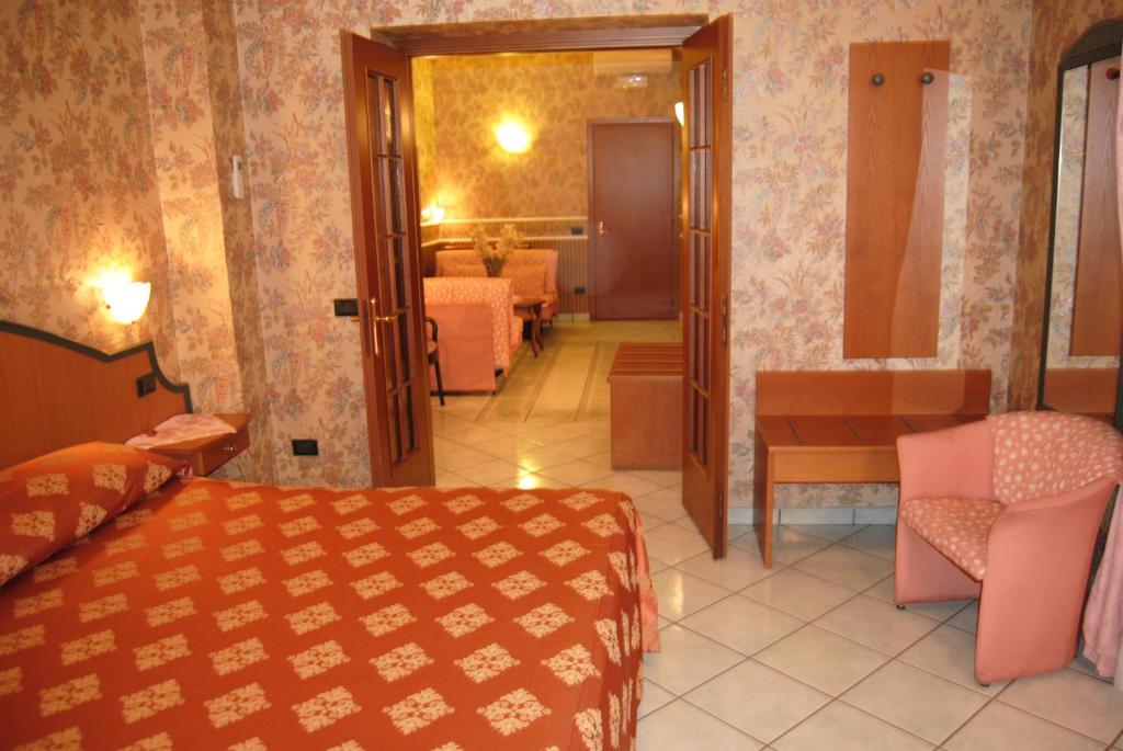 Postel nebo postele na pokoji v ubytování Hotel Nespolo D'Oro