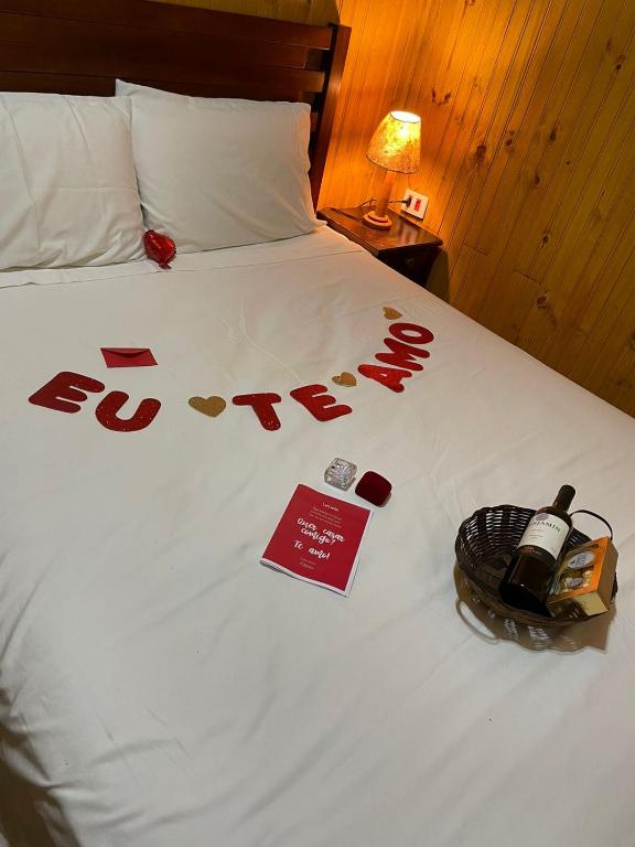 a bed with a sign that says love on it at CABANA SERRA DA BALANÇA in Gonçalves