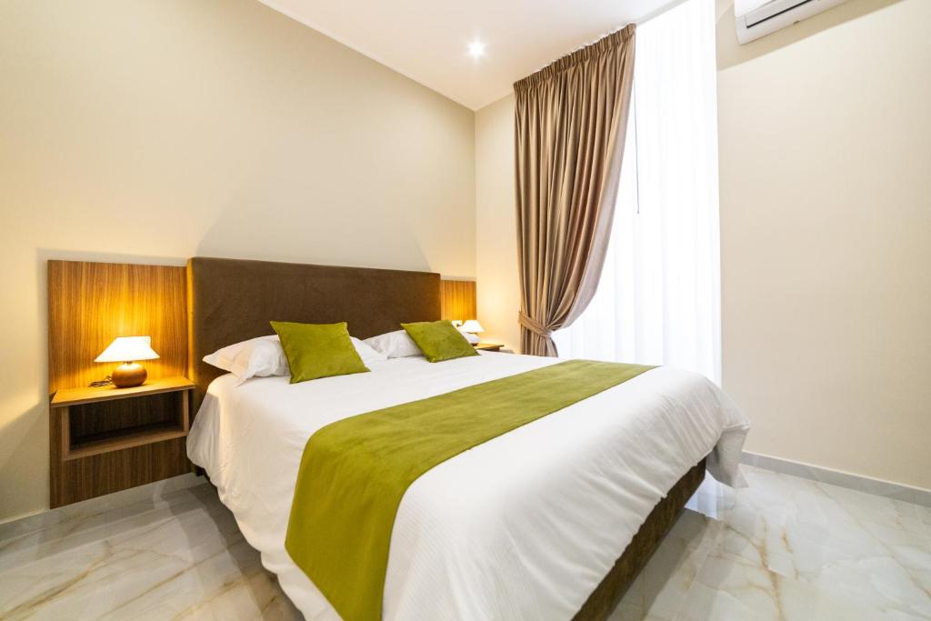 a bedroom with a large bed and a window at Station House 45 in Naples