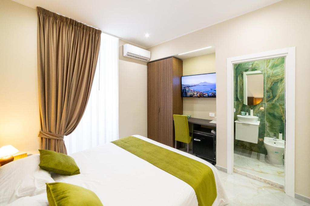 a hotel room with a bed and a bathroom at Station House 45 in Naples